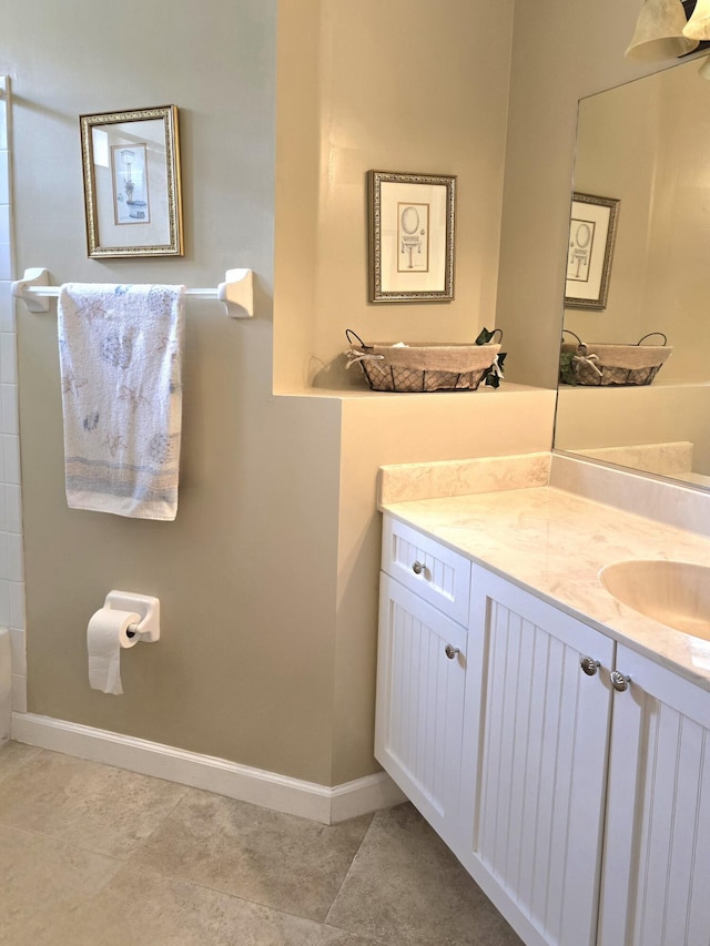 630 SW Treasure Cv, Port Saint Lucie, FL 34953 - full bathroom with vanity, baseboards, and tile patterned flooring