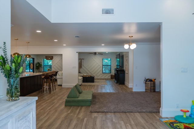4651 Turnberry Ct, Boynton Beach, FL 33436 - living area featuring crown molding, ceiling fan, visible vents, wood finished floors, and baseboards