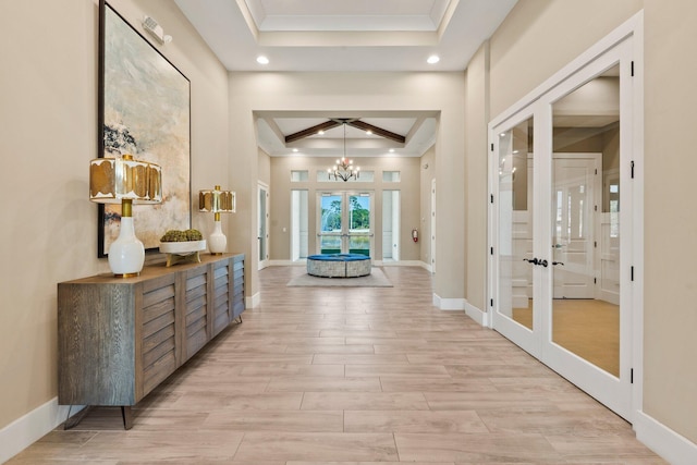 foyer with french doors, a tray ceiling, recessed lighting, and ornamental molding