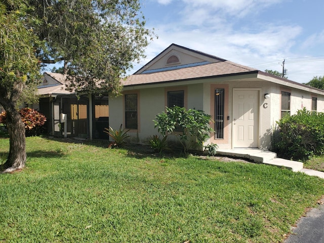 2831 Stoneway Ln Unit C, Fort Pierce, FL 34982 - view of front of home featuring a front yard, a shingled roof, and stucco siding