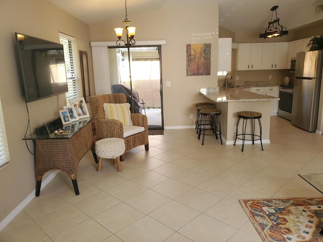 2831 Stoneway Ln Unit C, Fort Pierce, FL 34982 - kitchen with light tile patterned floors, white cabinets, a sink, appliances with stainless steel finishes, and a peninsula