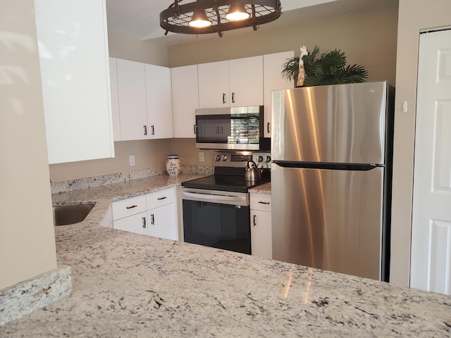 2831 Stoneway Ln Unit C, Fort Pierce, FL 34982 - kitchen with stainless steel appliances, light stone countertops, white cabinets, and a sink