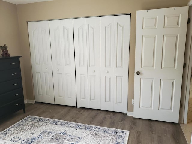 2831 Stoneway Ln Unit C, Fort Pierce, FL 34982 - bedroom with a closet, wood finished floors, and baseboards
