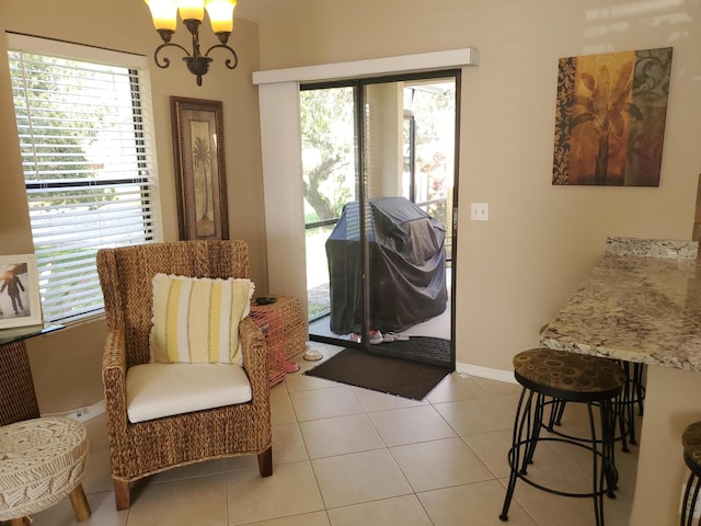 2831 Stoneway Ln Unit C, Fort Pierce, FL 34982 - foyer entrance featuring a healthy amount of sunlight, light tile patterned flooring, a notable chandelier, and baseboards