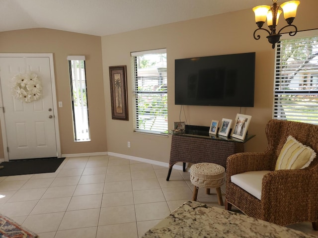 2831 Stoneway Ln Unit C, Fort Pierce, FL 34982 - foyer featuring an inviting chandelier, light tile patterned flooring, baseboards, and vaulted ceiling