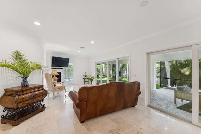 living room featuring a warm lit fireplace, visible vents, crown molding, and recessed lighting