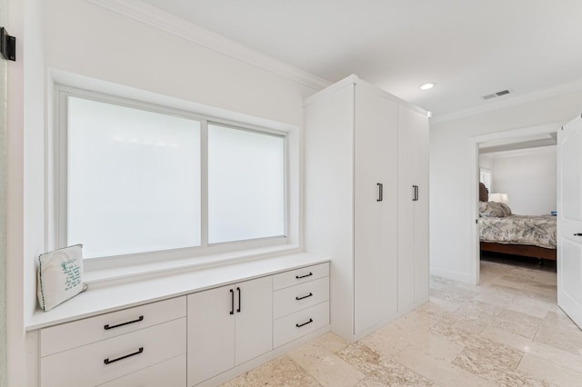 interior space with stone tile floors, visible vents, crown molding, and recessed lighting