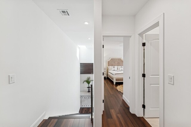 corridor featuring recessed lighting, visible vents, wood finished floors, and baseboards