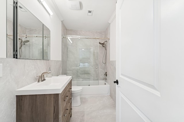 bathroom featuring tile walls, vanity, toilet, visible vents, and  shower combination