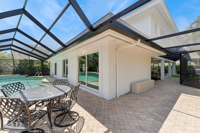 view of patio / terrace with outdoor dining area, an outdoor pool, and glass enclosure