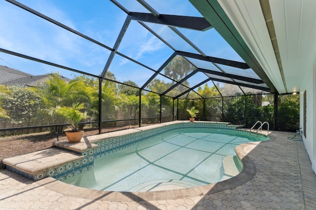 outdoor pool with a patio area and glass enclosure