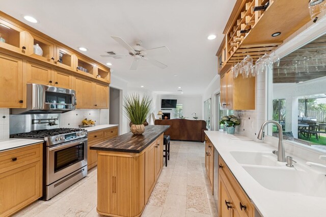 kitchen with glass insert cabinets, recessed lighting, stainless steel appliances, and decorative backsplash