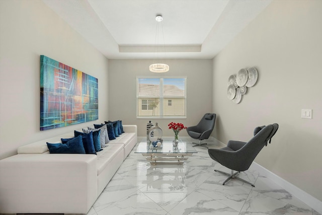 15649 Orchard Dr, Westlake, FL 33470 - living room featuring a raised ceiling, marble finish floor, and baseboards