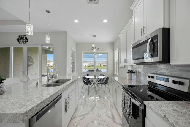15649 Orchard Dr, Westlake, FL 33470 - kitchen featuring white cabinets, recessed lighting, marble finish floor, a sink, and stainless steel appliances