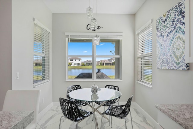 15649 Orchard Dr, Westlake, FL 33470 - dining space featuring baseboards, marble finish floor, a notable chandelier, and a healthy amount of sunlight
