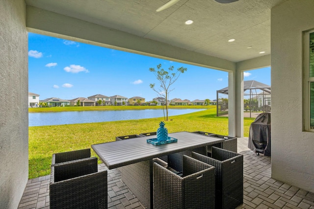 15649 Orchard Dr, Westlake, FL 33470 - view of patio featuring a lanai, outdoor dining space, a residential view, and a water view