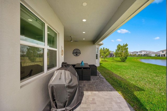 15649 Orchard Dr, Westlake, FL 33470 - view of patio featuring a water view, a residential view, grilling area, and a ceiling fan