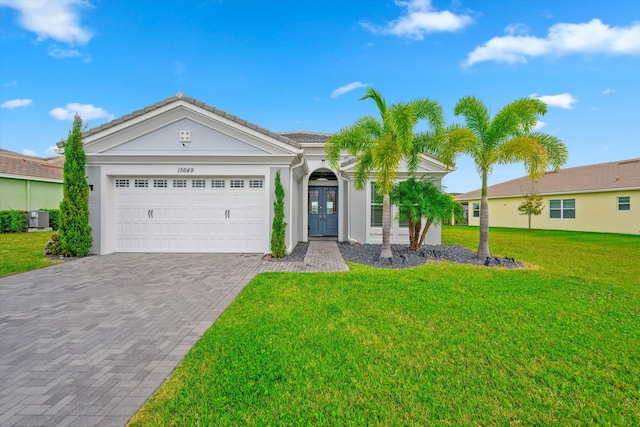 15649 Orchard Dr, Westlake, FL 33470 - single story home with a garage, stucco siding, french doors, a front lawn, and decorative driveway