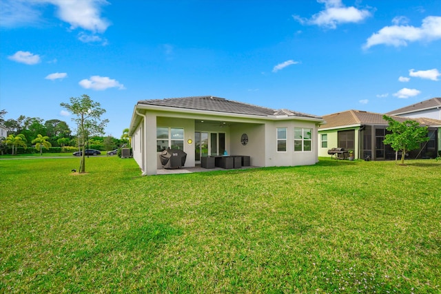 15649 Orchard Dr, Westlake, FL 33470 - back of property featuring a patio area, a tile roof, a lawn, and stucco siding