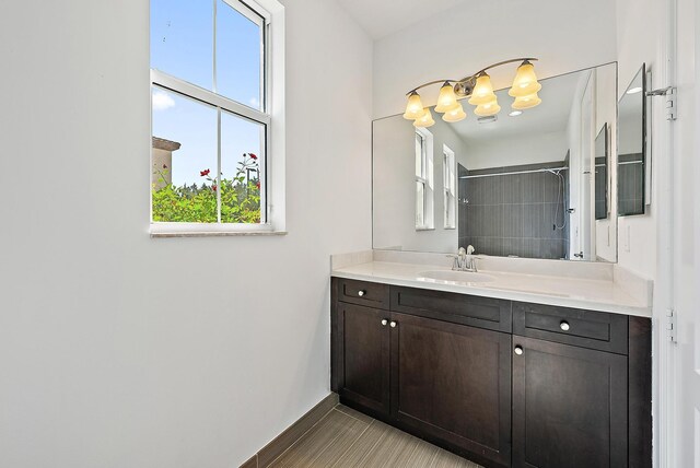 122 Diamante Way, Jupiter, FL 33477 - bathroom with vanity, tiled shower, baseboards, and a chandelier