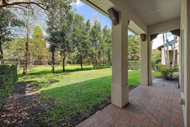122 Diamante Way, Jupiter, FL 33477 - view of grassy yard with a patio area and view of wooded area