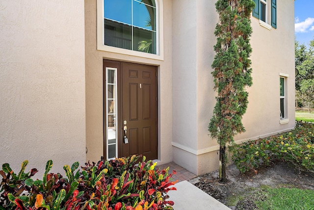 122 Diamante Way, Jupiter, FL 33477 - doorway to property with stucco siding