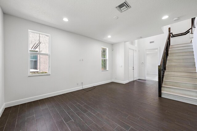122 Diamante Way, Jupiter, FL 33477 - empty room with stairs, baseboards, dark wood-style flooring, recessed lighting, and a textured ceiling
