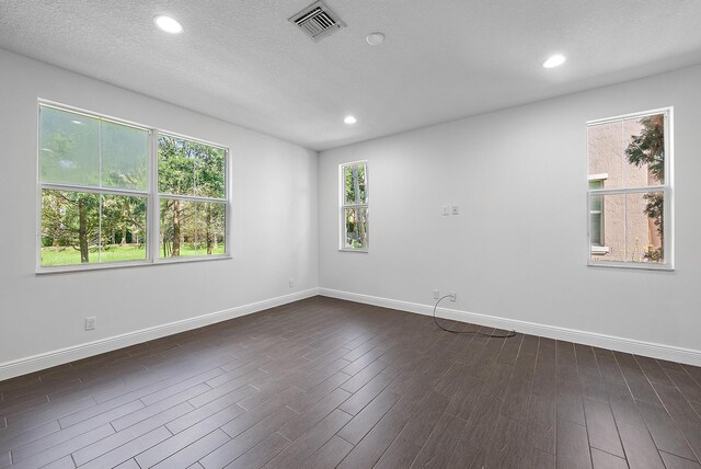 122 Diamante Way, Jupiter, FL 33477 - unfurnished room featuring baseboards, dark wood-style floors, recessed lighting, and a textured ceiling