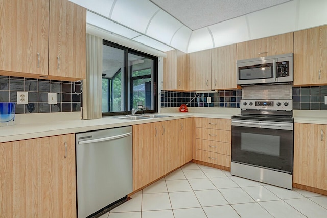 18356 181st Cir S, Boca Raton, FL 33498 - kitchen with appliances with stainless steel finishes, light countertops, decorative backsplash, a sink, and light brown cabinetry