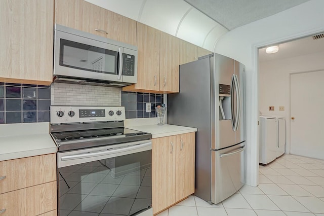 18356 181st Cir S, Boca Raton, FL 33498 - kitchen with separate washer and dryer, light brown cabinets, light tile patterned floors, light countertops, and stainless steel appliances