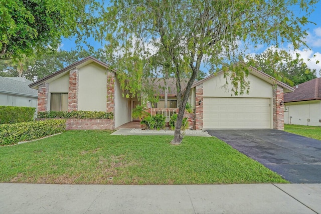 18356 181st Cir S, Boca Raton, FL 33498 - view of front facade with stucco siding, driveway, an attached garage, a front yard, and brick siding