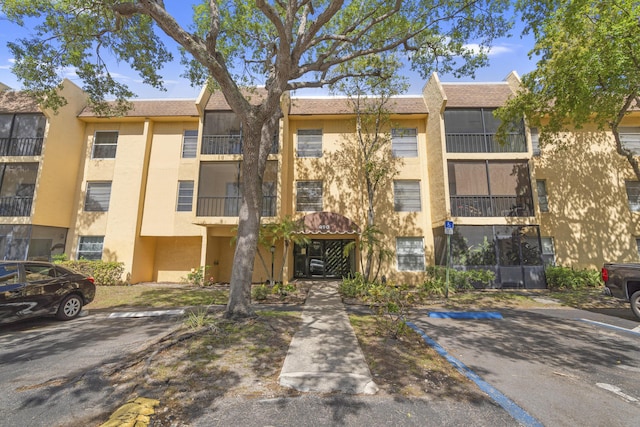 view of building exterior with uncovered parking