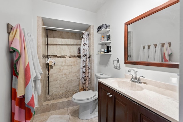 bathroom with vanity, a tile shower, and toilet
