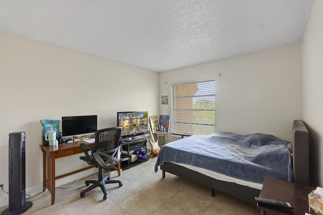 tiled bedroom featuring a textured ceiling