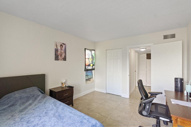 tiled bedroom featuring visible vents and baseboards