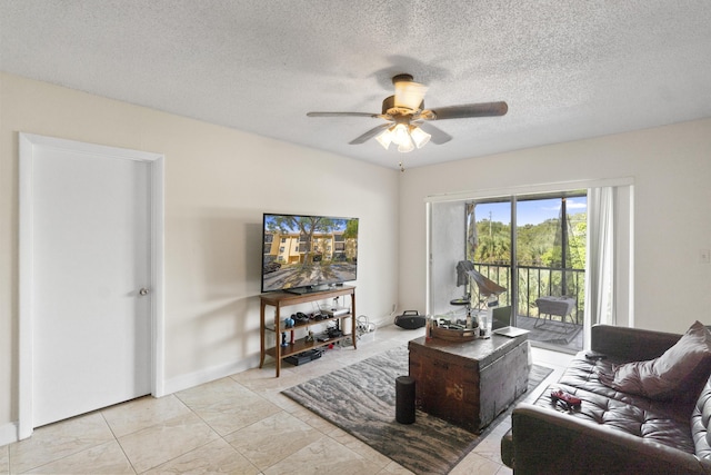 living room with a textured ceiling, baseboards, and a ceiling fan