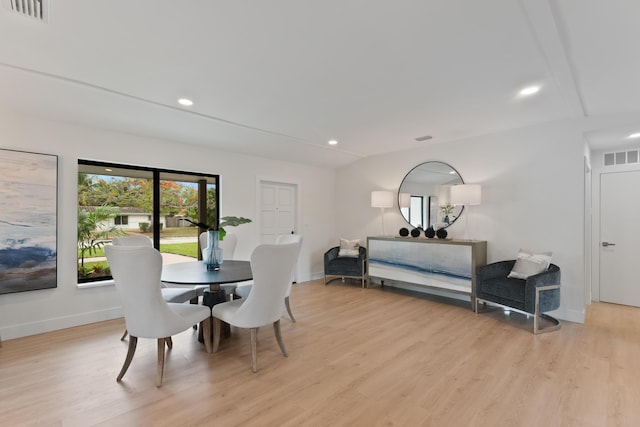 dining area featuring visible vents, light wood finished floors, recessed lighting, and lofted ceiling