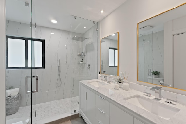 bathroom with a sink and a marble finish shower