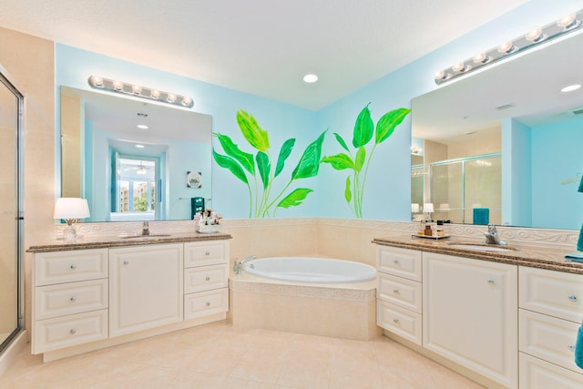 bathroom with two vanities, a shower stall, tile patterned flooring, and a sink