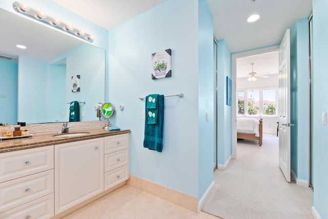 ensuite bathroom featuring recessed lighting, vanity, connected bathroom, baseboards, and ceiling fan