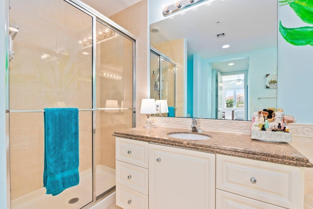bathroom featuring recessed lighting, a shower stall, visible vents, a ceiling fan, and vanity