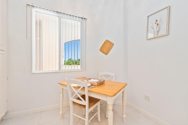 dining room with light tile patterned floors, a wealth of natural light, and baseboards