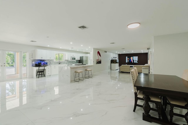 dining room with marble finish floor, recessed lighting, and visible vents