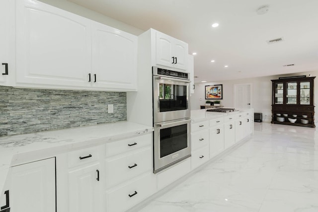kitchen with recessed lighting, marble finish floor, visible vents, decorative backsplash, and double oven