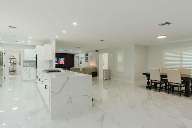 kitchen featuring recessed lighting, light stone counters, visible vents, gas cooktop, and white cabinets