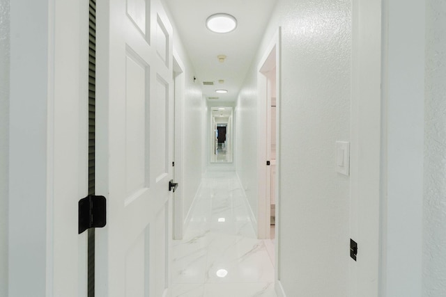 hallway with marble finish floor
