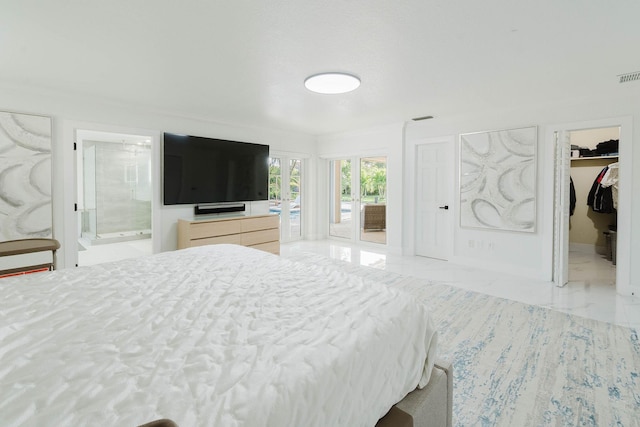 bedroom with marble finish floor, ensuite bath, visible vents, and a walk in closet