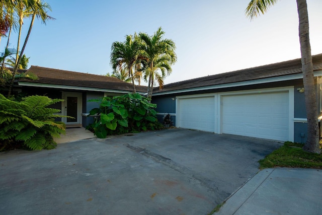 view of front facade with concrete driveway and a garage