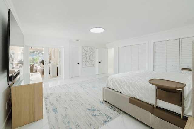 bedroom featuring ornamental molding and two closets