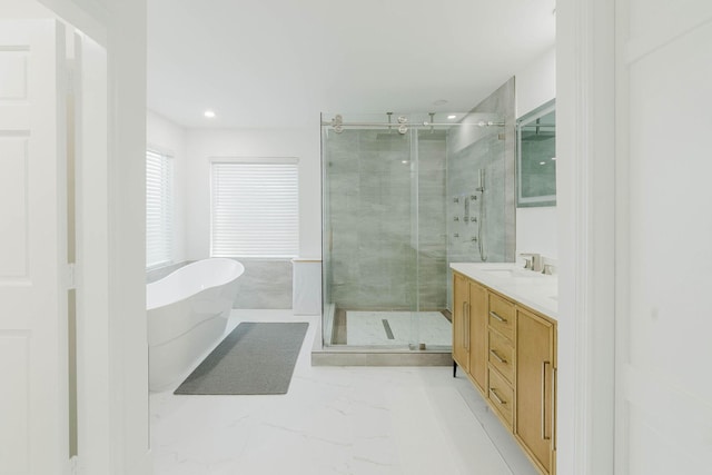 bathroom featuring recessed lighting, marble finish floor, a shower stall, vanity, and a freestanding tub